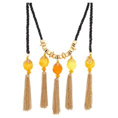 - Vintage item - Collectible costume jewelry piece from the '80s - Extremely rare, hard to find style - 70" length - 6" tassel drop - Gold plated hardware - Twisted black silk cord - Orange and yellow marbled faceted resin beads - Gold chain tassel - Can be worn as a necklace or belt - By Christian Lacroix (signed on hang tag) - Made in Paris, France - Circa 1980s - Estate acquired - Beautiful vintage condition with light fraying to silk cord (see photos) Silk Cord Necklace, Resin Chain, Find Style, Silk Cord, Star Jewelry, Rope Necklace, Pearl Strands, Resin Beads, Orange And Yellow