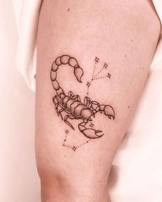 a small scorpion tattoo on the right arm and leg, with stars in the background