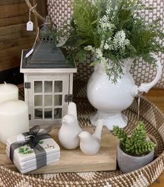 a basket filled with candles and flowers on top of a wooden table next to a candle holder