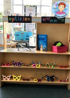 the display case is filled with different types of sunglasses and other items for children's eyeglasses