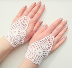 two hands with lacy white lace on them