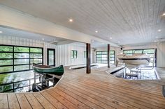 the inside of a house with a boat in the water