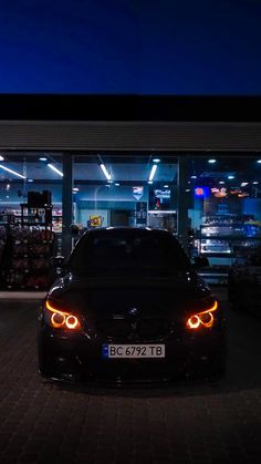 a car parked in front of a store at night