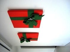 two red boxes with green bows on the ceiling