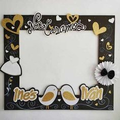 a photo frame with two birds and hearts on the side, decorated with gold glitters