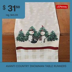 a table runner with two snowmen on it and the price is $ 31 50