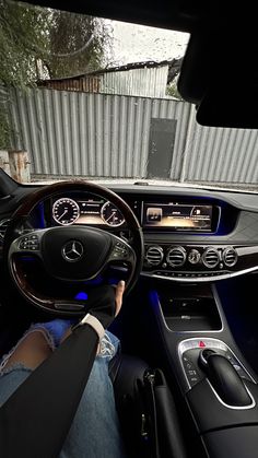 the interior of a mercedes benz car with its dashboard illuminated by blue lights and steering wheel controls