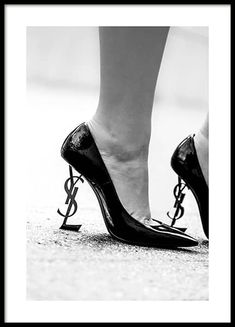 – Black and white photograph of a pair of heels with the YSL logo as the heel 				Gallery wall and picture wall inspiration - Desenio.com Prada Poster, Desenio Posters, Ysl Heels, Black And White Canvas, White Heels, Fashion Poster, Black High Heels, Black And White Photographs, Flower Fashion