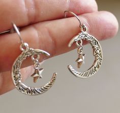 "Crescent moon star earrings. Antique silver tone crescent moon and star charms dangling from hypoallergenic stainless steel hooks with rubber backs. Earring length: 38mm, 1.5\" Charm material: zinc alloy, lead free cadmium free This listing is for one pair of mon and star earrings with rubber backs. This earring will come in a gift bag. I offer combined shipping costs which give you a shipping discount for ordering multiple items from my shop. Earrings care: Take them off while you sleep, sport Sterling Silver Moon Charm Earrings For Everyday, Hypoallergenic Sterling Silver Crescent Jewelry, Hypoallergenic Crescent Sterling Silver Jewelry, Silver Moon Charm Earrings For Everyday, Silver Sterling Hoop Earrings With Moon Charm, Everyday Silver Earrings With Moon Charm, Crescent Silver Hoop Earrings With Moon Charm, Silver Dangle Hoop Earrings With Moon Charm, Adjustable Crescent Sterling Silver Hoop Earrings