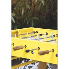 a close up of a foosball table with wooden handles and small figurines on it