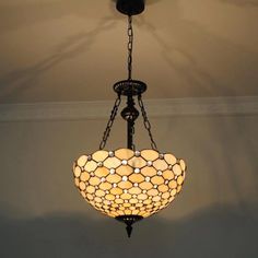 a chandelier hanging from the ceiling in a room