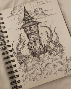 a spiral notebook with a drawing of a castle in the sky on top of clouds