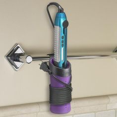 a blue and purple electric toothbrush holder on the side of a white brick wall