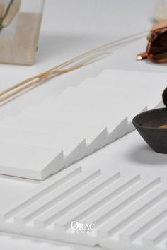 a pair of sunglasses sitting on top of a table next to some papers and other items