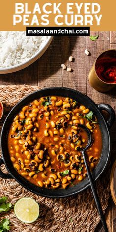 black eyed peas curry in a skillet with limes and rice on the side