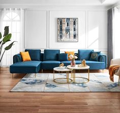 a modern living room with blue couches and rugs on the wooden flooring