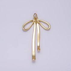 Description: - Material: Brass, 14K Gold Filled - Size: 33.4mm x 19mm x 2.4mm  - Bail Size: 1.2mm  - Quantity: 1 piece - Color: Gold - Lead Free, Nickel Free Please avoid chemical solutions, perfumes, excessive sweat, seawater and/or pool water. Salt water and chlorine can damage your jewelry. Chlorine can damage and discolor metals that are alloyed with the gold and can slowly erode the finish and polish of gemstones.Also, lotions and sprays create a film on the jewelry, making it dull and ding Metal Charm, Keep Jewelry, Ribbon Bow, Gold Charm, Gold Gold, Ribbon Bows, Jewelry Findings, Charm Jewelry, Hair Clip