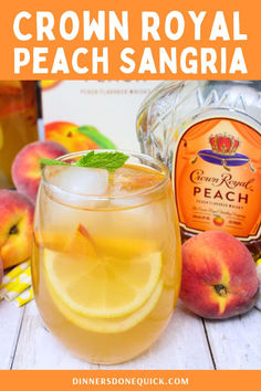 a glass filled with peach sangria next to sliced peaches and a bottle of crown royal peach sangria