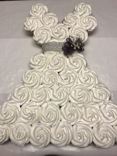 a cake shaped like a dress made out of cupcakes