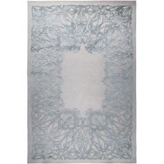 a white and blue rug with an intricate design in the center, on top of a gray floor