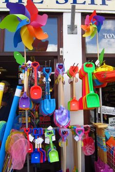 colorful garden tools are on display in front of the store