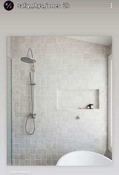 an image of a bathroom setting with white tiles on the shower wall and bathtub