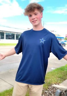 a young man standing next to a skateboard