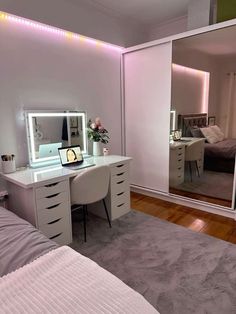 a bedroom with a bed, desk and mirror