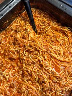 a large pan filled with spaghetti and meat