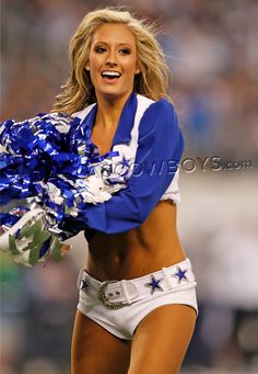 a cheerleader is smiling and dancing on the field