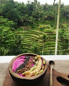 a wooden bowl filled with food on top of a table