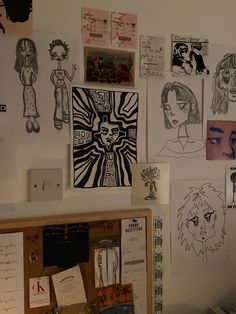 the wall is covered with drawings and posters