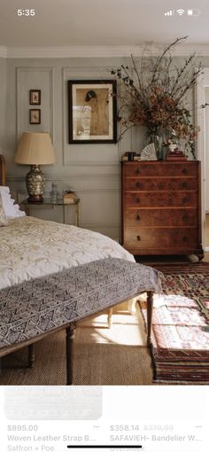 a bed sitting in a bedroom next to a dresser and lamp on top of a rug