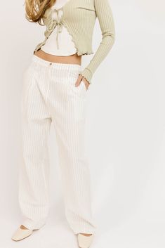 the definition of bomb af bottoms, these slouchy pinstripe linen pants are full of ways to wear. they have that relaxed, cool street style fit, so they’re perfect for beach days, date nights, + weekend hangs. white + black stripes // wide leg, one button zip fly, pockets, belt loops, pleat detailing, exposed hem detailing at waist paired with our july tie top model is 5'8" + wearing a small measurements are approximate + taken while laying flat small : waist 29” inseam 28” length 40” medium : wa Spring Striped High-waisted Wide Leg Pants, Spring Wide-leg Pants With Vertical Stripes, Spring Striped Wide Leg Pants With Relaxed Fit, Pinstripe High Waist Pants For Spring, Straight Pants With Contrast Stripes For Spring, Striped Wide Leg Linen Pants, Relaxed Fit Striped Wide Leg Pants For Spring, Striped Linen Wide Leg Pants, Pinstripe High-waisted Pants For Spring