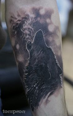 a man with a wolf tattoo on his arm