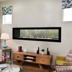 a living room filled with furniture and a flat screen tv mounted to the wall over a fireplace