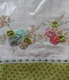 an embroidered piece of cloth with flowers on it