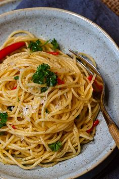 a white plate topped with pasta and parsley