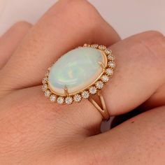 This Welo Opal vintage style ring features a 14K yellow gold setting, a Full Fire Jelly Opal, and a natural earth-minded diamond halo with milgrain detail. An Art Deco ring design perfect for an eye-catching engagement or anniversary. This ring also makes a beautiful October birthstone gift for your loved ones! This ring is made with solid 14K Gold and naturally Earth-mined SI / G-H diamonds. Vintage Opal Engagement Ring, Opal And Diamond Ring, Jelly Opal, Designer Silver Jewellery, Vintage Style Rings, Jewelry Showcases, Engagement Rings Opal, Yellow Gold Setting, Birthstone Gifts