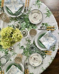 the table is set with green and white china