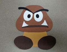 a paper cut out of a cartoon character sitting on the floor with its eyes wide open