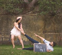 a man is trying to push a woman on the ground while she holds her hand out