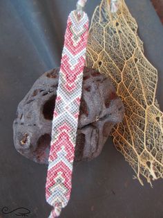 two pieces of fabric tied together next to a rock