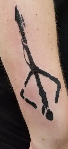 a man's arm with a black ink drawing of an arrow on the forearm