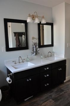 a bathroom with two sinks and mirrors on the wall