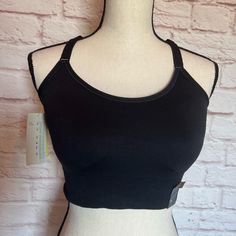 Brand New With Tags And Never Worn. Black Cami Sports Bra With Removable Cups And Halter Back. It Offers Medium Support And Moisture Wicking Material. Size Is A Xxl. Black Stretch Bra With Light Support, Black Yoga Bra With Medium Bust Support, Black Camisole Sports Bra For Workout, Black Bra With Adjustable Straps And Medium Support, Black Bra With Medium Bust Support And Stretch, Black Seamless Yoga Bra, Seamless Black Yoga Bra, Light Support Sleeveless Fitted Bra, Stretch Camisole Nursing Bra With Built-in Bra