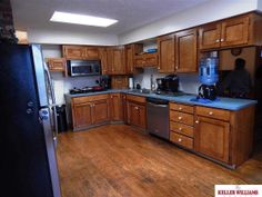 a kitchen with wooden cabinets and stainless steel appliances