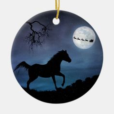 a christmas ornament with a horse and sleigh in the sky at night