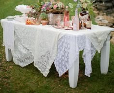 a table with flowers and candles on it