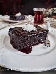 a piece of chocolate cake sitting on top of a white plate